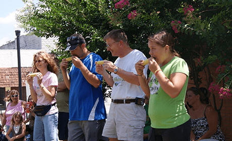 A group of people eating food from bananas.